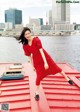 A woman in a red dress standing on a red platform.